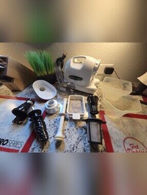 Omega White Juicer with Multiple Black and White Attachments